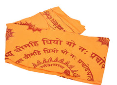 Folded yellow shawl with large red mantra text, Om symbols, and decorative motifs