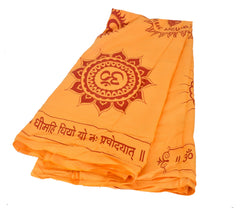Neatly folded yellow shawl with red Om emblem and mantra line; lightweight fabric