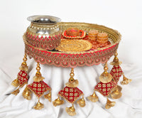 Handcrafted pooja thali plate with silver channi, red-and-gold decor, dangling tassels