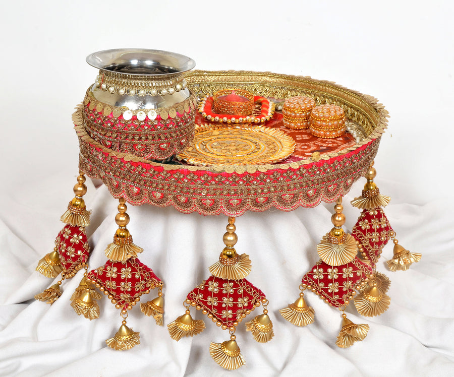 Handcrafted pooja thali plate with silver channi, red-and-gold decor, dangling tassels