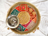 AONA INDIA handcrafted pooja thali plate top view with silver bowl and red, green, gold motifs