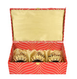 Diwali puja box lid open, showing three brass seated deities on lotus-shaped bases