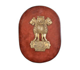 Brass Ashoka Stambh emblem on oval wooden plaque, golden lion capital and wheel base