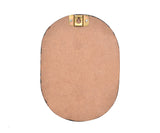 Back view of oval wooden plaque with two brass hanging hooks at the top