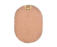 Back view of oval wooden plaque with two brass hanging hooks at the top