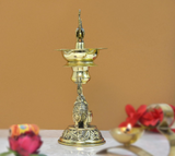 Brass elephant diya oil lamp, side view of peacock finial and carved base
