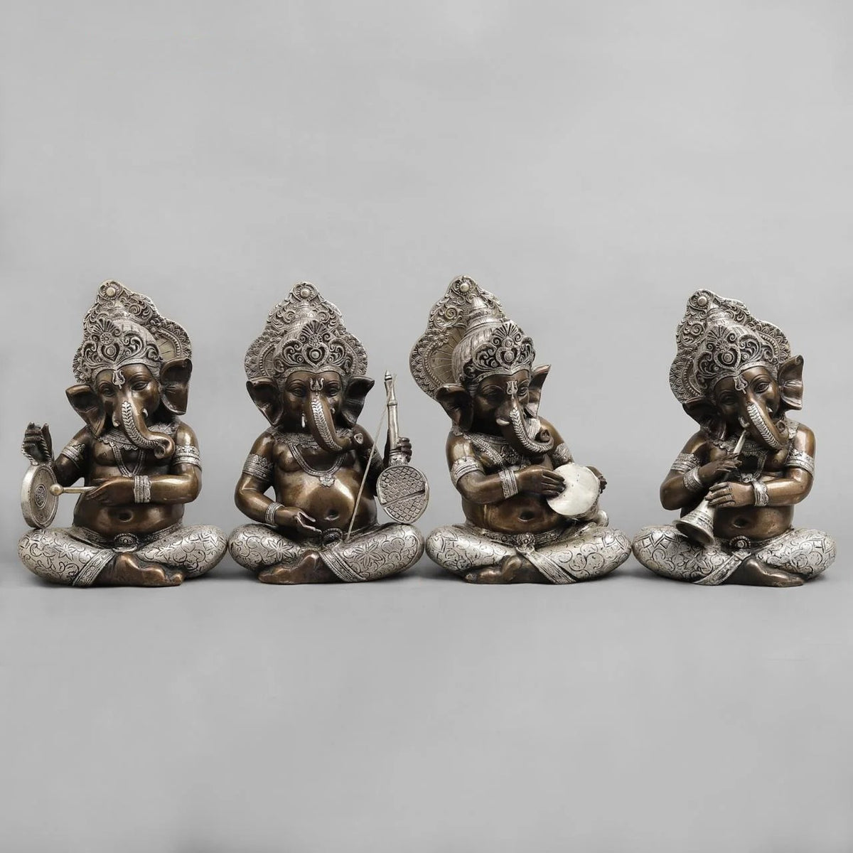 Brass musician Ganesh idol, seated with ornate crown and hands holding instruments