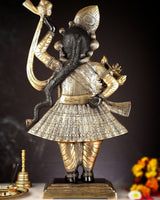 Brass Shrinath Ji murti side view, detailed jewelry and patterned robe with raised arm