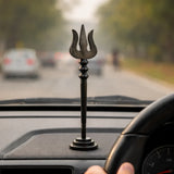 Dark metal Shiva trishool candle holder with round base, standing upright