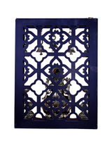Decorative brass lattice with hanging bells above Ganesha on lotus base