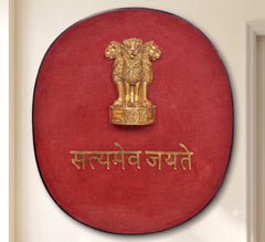 Round brass wall plaque with red background, black edge, golden Ashoka emblem and Hindi text