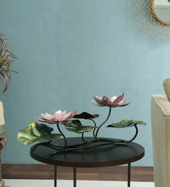 Iron lotus showpiece with pink flowers on black circular base, green leaf accents