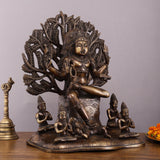 Brass Dakshinamurthy statue, seated pose with ornate halo and small seated figures