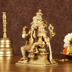 Brass Ganapati statue with ornate crown and two-arm pose, standing on carved base