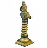 Brass Patanjali statue side view with folded palms and coiled hair, green-gold finish.