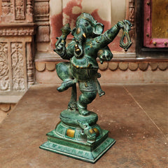 Dancing Ganesha brass idol, one leg lifted, detailed ornaments and jeweled accents on base