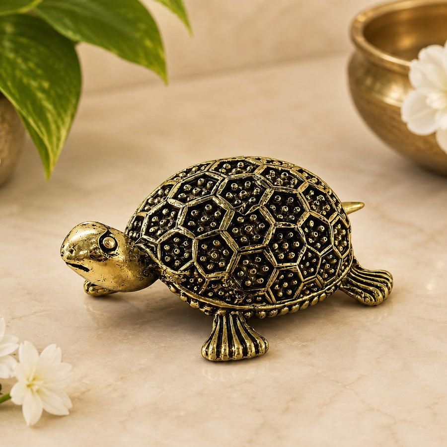 Brass turtle statue with textured patterned shell and small gold feet