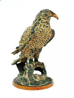 Brass eagle figurine close-up front view with orange beak, layered feather detail