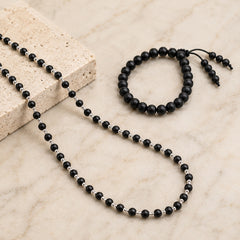 Black bead necklace with silver-toned spacers and matching bracelet, cap-style clasp