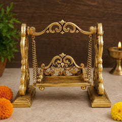Ornate brass swing cradle with chains and carved back, traditional Laddu Gopal style