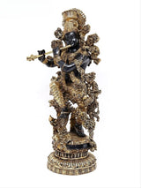 Brass Krishna figurine with flute, dark face, elaborate gold garments and jewelry