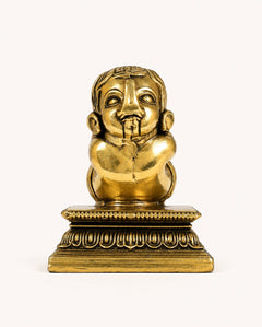 Brass Baby Ganesha figurine with face detail, seated meditation pose on ornate pedestal