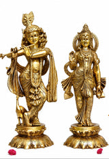 Brass Radha and Krishna idols standing side by side, detailed crowns and jewelry