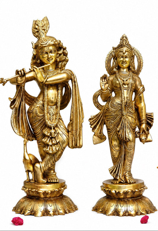 Brass Radha and Krishna idols standing side by side, detailed crowns and jewelry