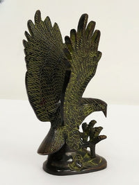 Brass eagle figurine with wings wide, head turned, carved talons and feather lines, 8 in