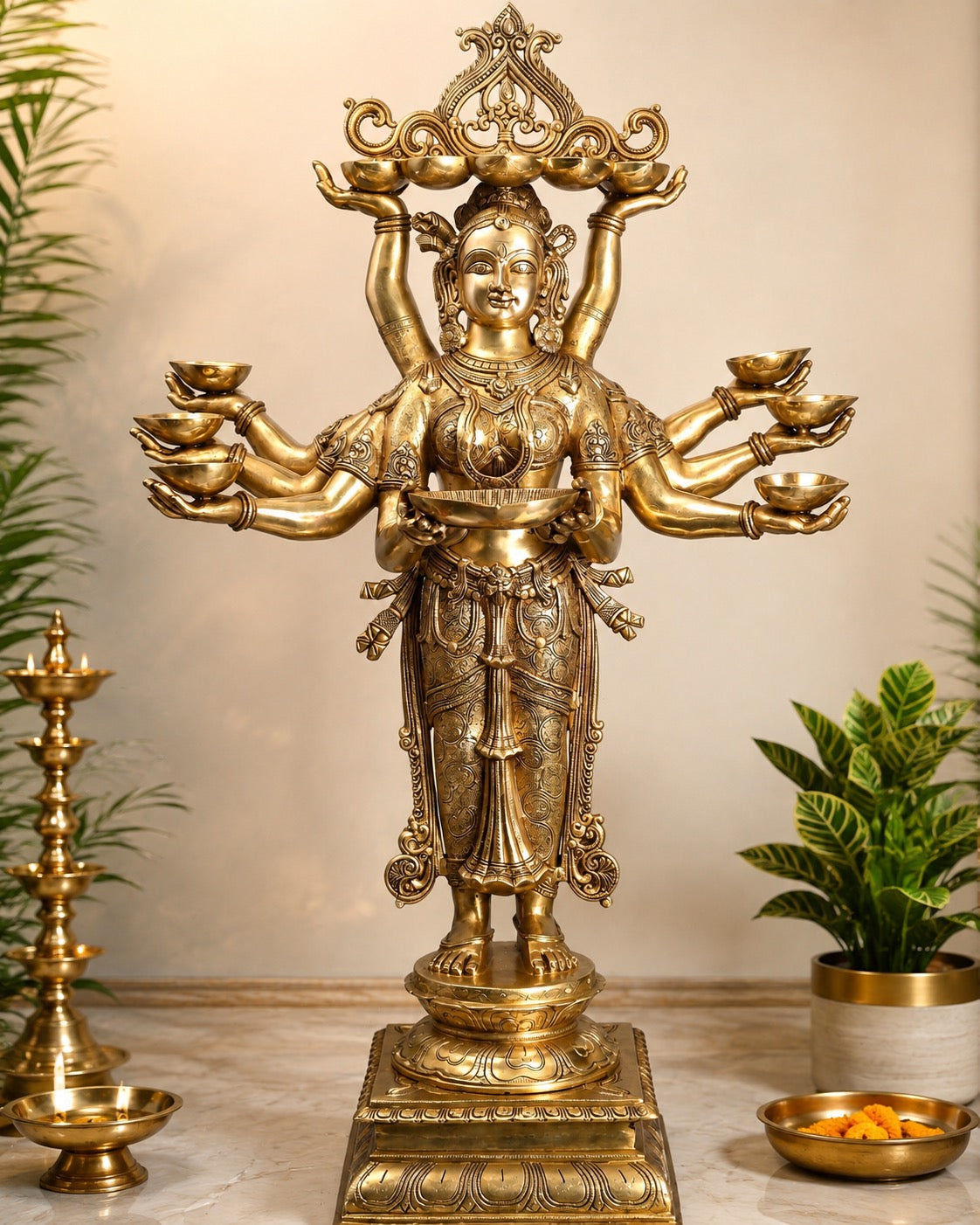Brass multi-armed goddess statue with diya holders on both hands, ornate standing figure
