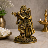 Antique brass Radha-Krishna idol with flute, two figures on ornate round base