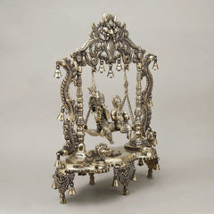 Brass Radha and Krishna swing jhula with sculpted figures and decorative frame