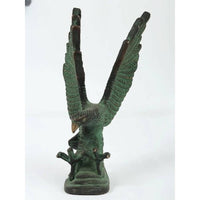 Brass green Patna eagle sculpture, wings spread upward on a dark base, 8 in height