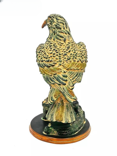 Brass eagle figurine standing on round base, ornate feather engraving, orange beak
