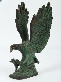 Full view of green Patna eagle sculpture with wings wide, dark patina highlights, stable base