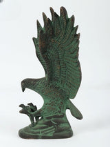 Rear view of green eagle sculpture, fan-like wings with intricate feather etching on base