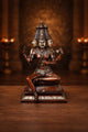 Copper finish seated Brahma sculpture with four arms, detailed headdress, 16 in