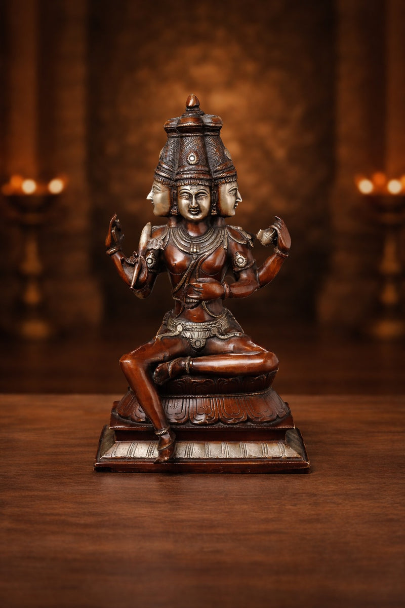 Copper finish seated Brahma sculpture with four arms, detailed headdress, 16 in