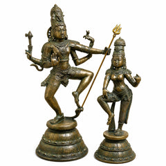 Brass Shiva dancing with raised trident beside Parvati standing, antique gold and green finish