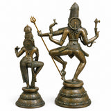 Brass Shiva dancing with trident, Parvati seated beside, antique gold and green finish