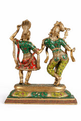 Angled view of multicolour brass Radha-Krishna dancing idols in green-red attire