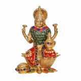Brass Lakshmi statue, raised hands and jeweled green bodice, red skirt on lotus pedestal