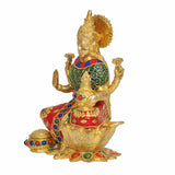 Brass Lakshmi statue side view, ornate crown, jeweled green-and-red outfit on lotus base