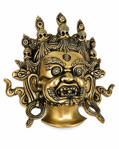Brass Mahakaal Jambala face wall hanging, detailed gold deity mask with crown-like spikes
