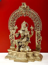 Brass Lord Narasimha statue, raised hands, decorative arch and base, three-quarter view