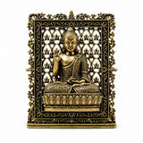Brass Buddha panel with ornate filigree frame, seated figure in gold tone