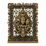 Brass dashboard panel with ornate filigree frame and seated deity in center