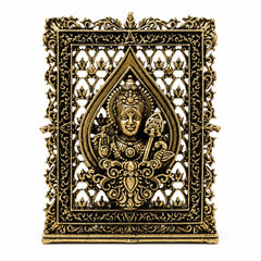 Brass dashboard panel with ornate filigree frame and seated deity in center