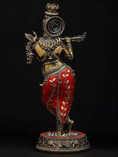 Back view of brass Murari Krishna idol playing flute, ornate headpiece and red patterned dhoti