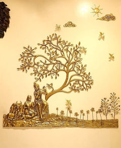 Brass Radha Krishna wall decor: seated figures beneath a sculpted tree with butterflies